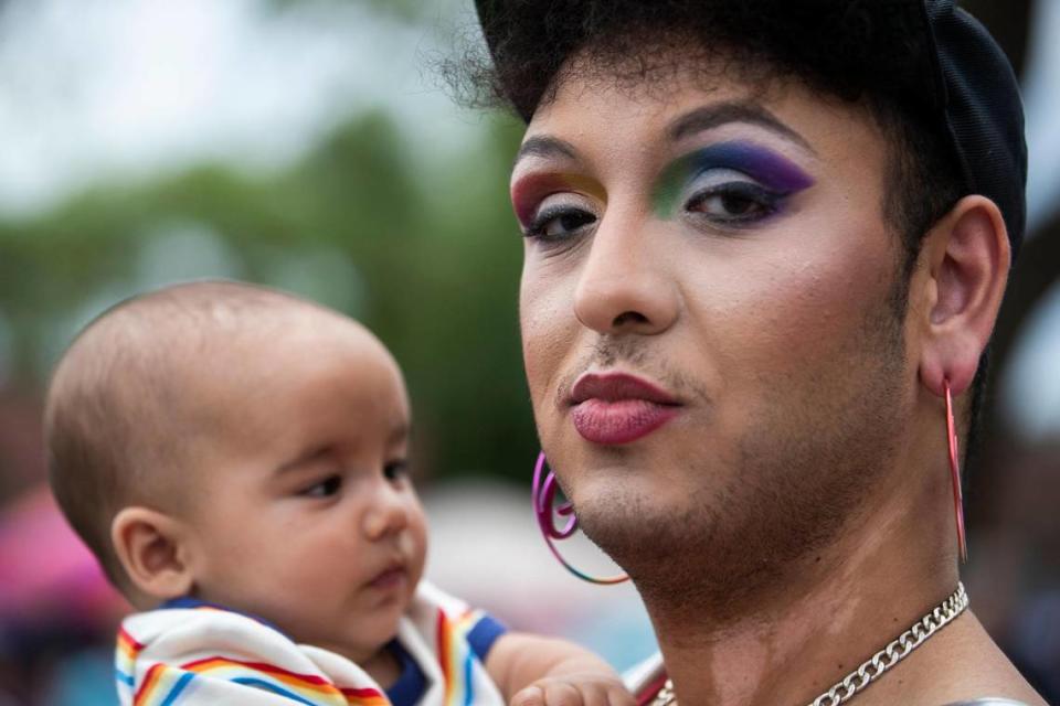 Mo Isfail holds Oliver Perry, a four-month-old baby, at OutFest in Columbia, South Carolina on Saturday, June 6, 2021. Isfail is neighbor’s with Perry’s parents, and ran into multiple friends and neighbors at the festival.