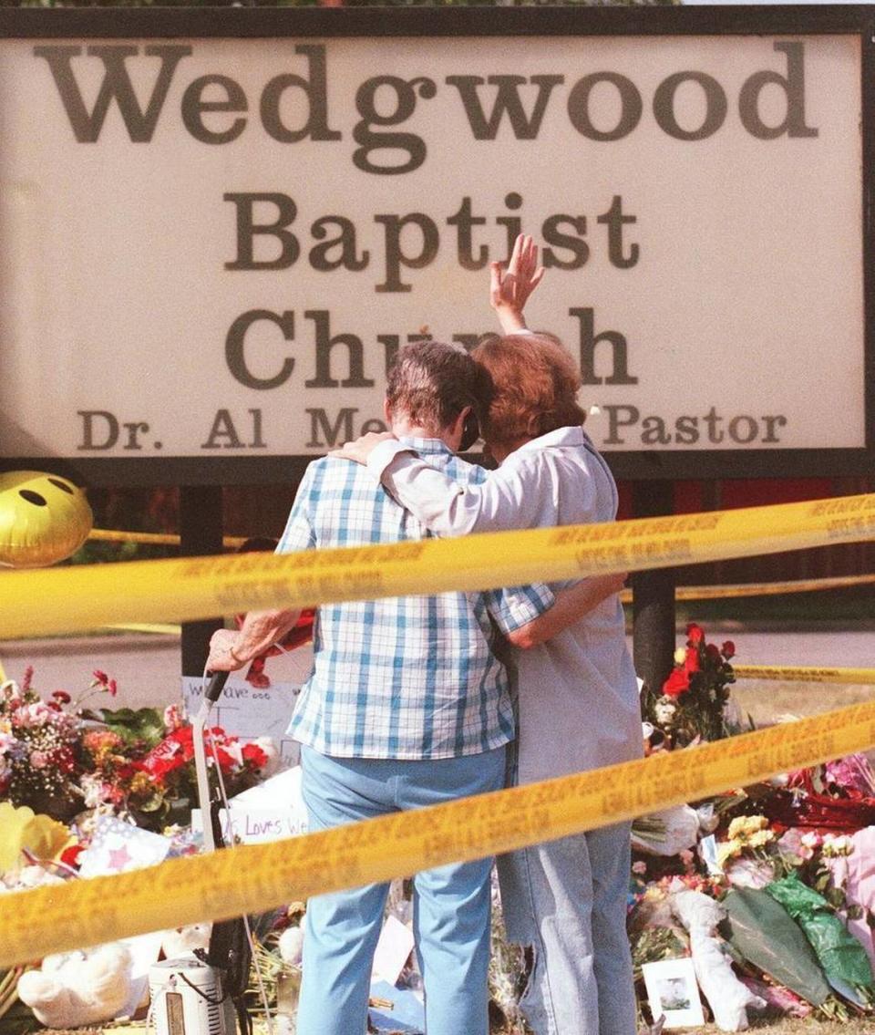 Two women pray for the shooting victims at Wedgwood Baptist Church Fort Worth in 1999.