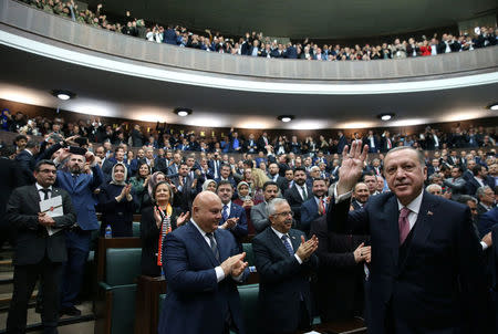 Turkish President Tayyip Erdogan greets members of parliament from his ruling AK Party (AKP) during a meeting at the Turkish parliament in Ankara, Turkey, February 20, 2018. Murat Cetinmuhurdar/Presidential Palace/Handout via REUTERS