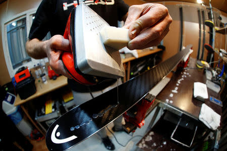 Heinz Haemmerle, or "Magic Heinzi" as US skier Lindsey Vonn calls her Austrian-born ski technician, puts on wax on a pair of skis of the world's most successful skiing women in his tiny waxing container at the Winter Olympics 2018 in Pyeongchang, South Korea February 19, 2018. Picture taken February 19, 2018. REUTERS/Leonhard Foeger