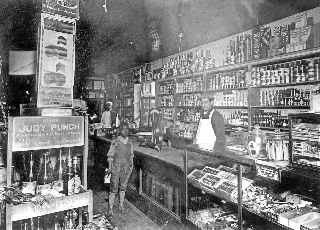 Nicolas Debs tends the counter at Debs Store in the 1930s in Jacksonville. The family's old store is now the centerpiece of an ambitious renovation plan to once again provide fresh produce and food to the Eastside, as well as banking and employment services.