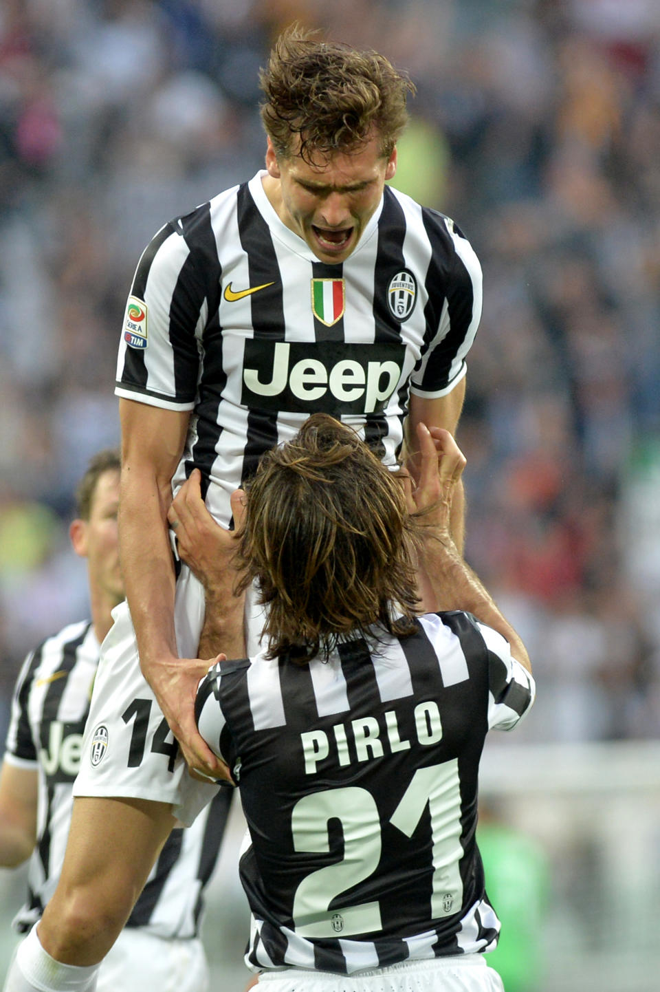 Juventus forward Fernando Llorente, of Spain, celebrates after scoring with teammates Andrea Pirlo during a Serie A soccer match between Juventus and Livorno at the Juventus stadium, in Turin, Italy, Monday, April 7, 2014. (AP Photo/Massimo Pinca)