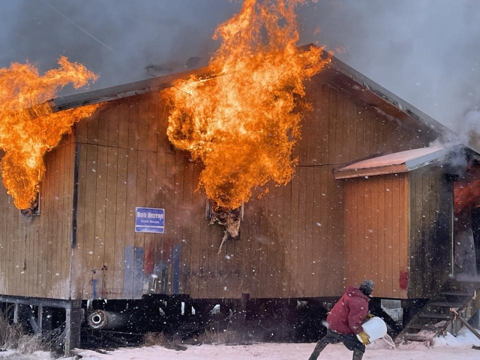 A resident in the 457-person village of Tuluksak in western Alaska tries in vain to slow the Jan. 16 fire that burned its only source of drinking water. Weeks later, residents still depend on donated drinking water while hoping they won’t wind up as another example of the needs of Alaska’s indigenous people in the bush being ignored.