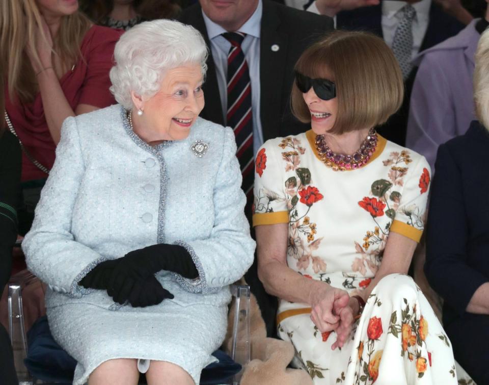 Anna Wintour: The Queen smiles while in conversation with <i>Vogue</i> editor Anna Wintour as the pair watch Richard Quinn's runway show at London Fashion Week, 20 February 2018 (Getty Images)