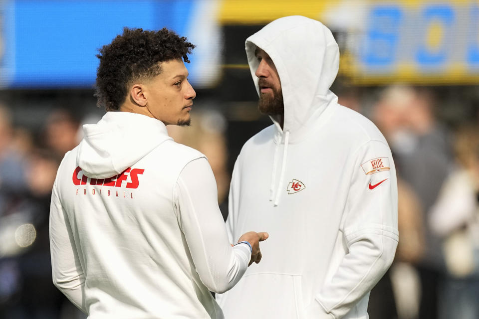 Kansas City Chiefs quarterback Patrick Mahomes, left, talks with tight end Travis Kelce before an NFL football game against the Los Angeles Chargers, Sunday, Jan. 7, 2024, in Inglewood, Calif. (AP Photo/Mark J. Terrill)