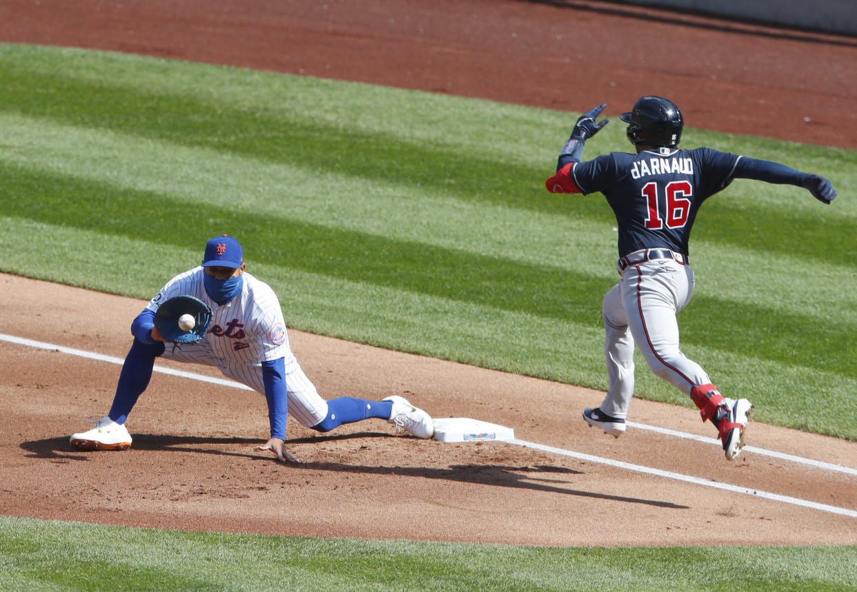 New York Mets first baseman Dominic Smith (2) catches the ball from starting pitcher Rick Porcello to get out Atlanta Braves catcher Travis d'Arnaud (16) during the first inning of a baseball game, Sunday, Sept. 20, 2020, in New York. (AP Photo/Noah K. Murray)