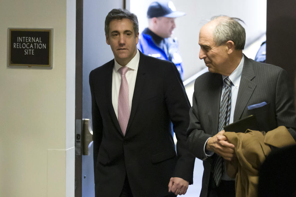 Michael Cohen, left, President Donald Trump's former lawyer, arrives to testify before a closed door hearing of the Senate Intelligence Committee accompanied by his lawyer Lanny Davis of Washington, on Capitol Hill, Tuesday, Feb. 26, 2019, in Washington. (AP Photo/Alex Brandon)