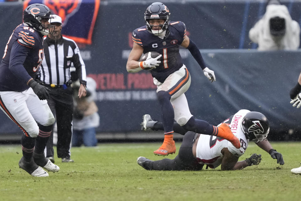 Chicago Bears quarterback Justin Fields (1) breaks away in the second half of an NFL football game against the Atlanta Falcons in Chicago, Sunday, Dec. 31, 2023. (AP Photo/Charles Rex Arbogast)