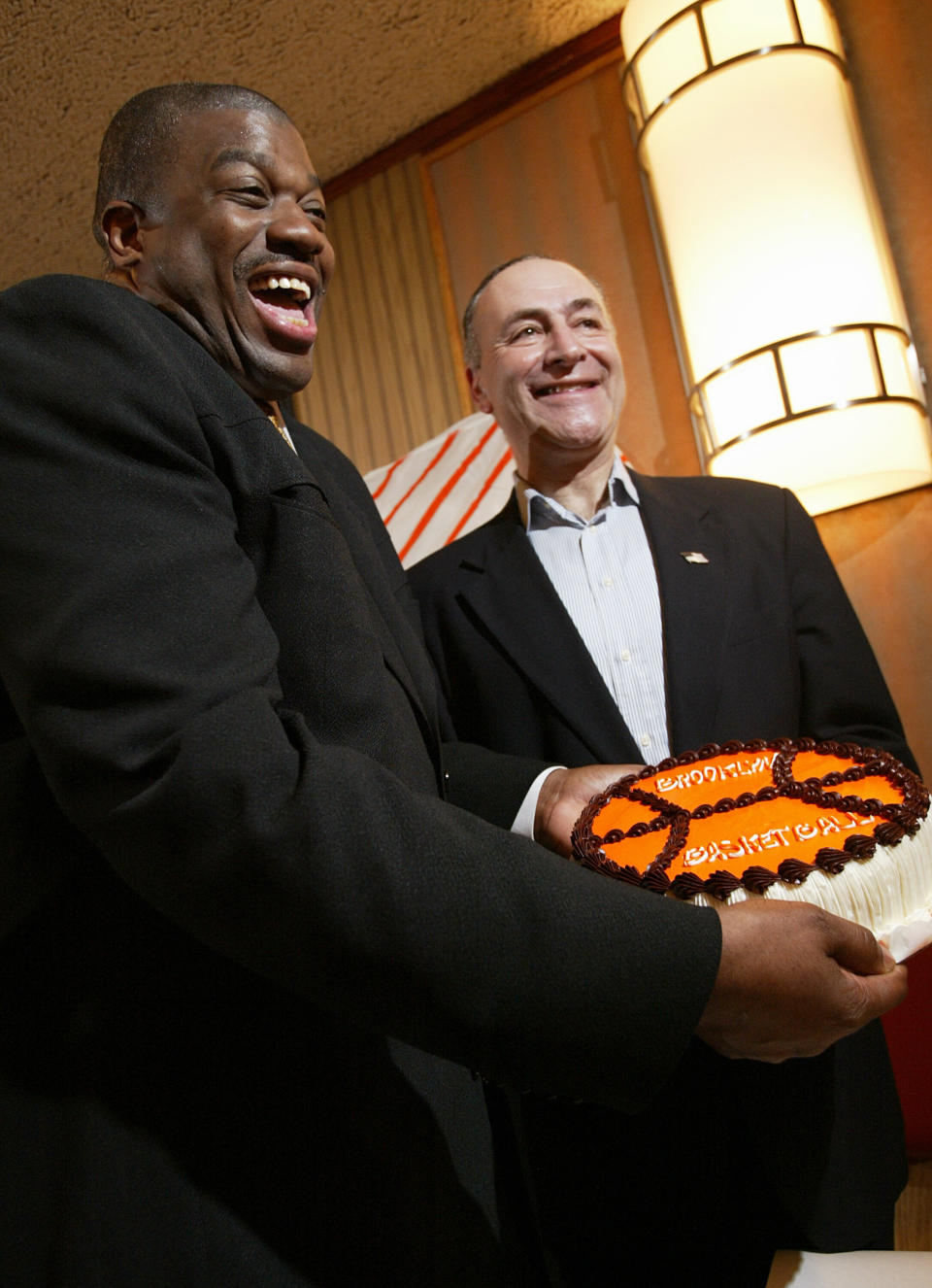 Sen. Chuck Schumer poses with basketball player Bernard King and a Junior's cheesecake during a press conference focused on moving the New Jersey Nets to Brooklyn in 2004. (Photo: New York Daily News via Getty Images)