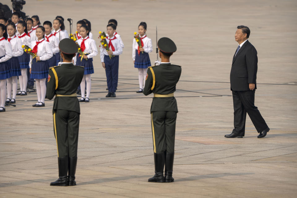 Chinese President Xi Jinping, right, walks during a ceremony to mark Martyr's Day at the Monument to the People's Heroes at Tiananmen Square in Beijing, Friday, Sept. 30, 2022. (AP Photo/Mark Schiefelbein)