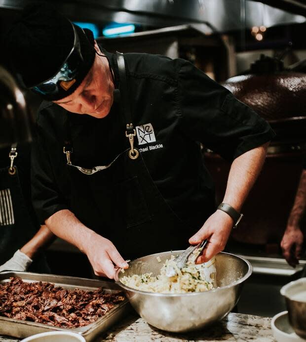 Chef Michael Blackie of NeXT restaurant in Stittsville, seen here in a crowded kitchen before the COVID-19 pandemic. Blackie says he plans to continue spacing out his dining after the pandemic in order to make it easier on his 'back of house' staff.