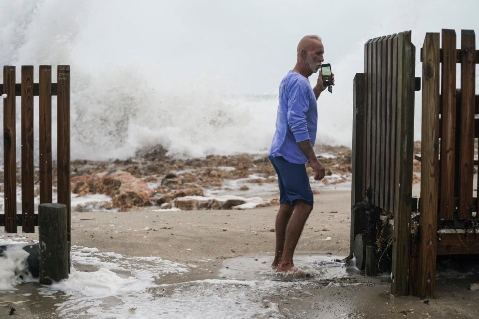 Water reaches the parking lot of the House of Refuge Museum and Southeast MacArthur Boulevard from the high surf caused by Tropical Storm Nicole on Wednesday on south Hutchinson Island in Florida.