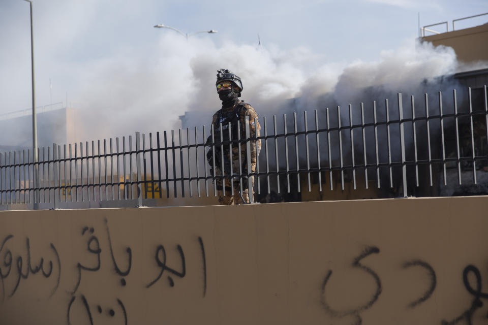 Iraqi army soldiers are deployed in front of the U.S. embassy, in Baghdad, Iraq, Wednesday, Jan. 1, 2020. Iran-backed militiamen have withdrawn from the U.S. Embassy compound in Baghdad after two days of clashes with American security forces. (AP Photo/Nasser Nasser)