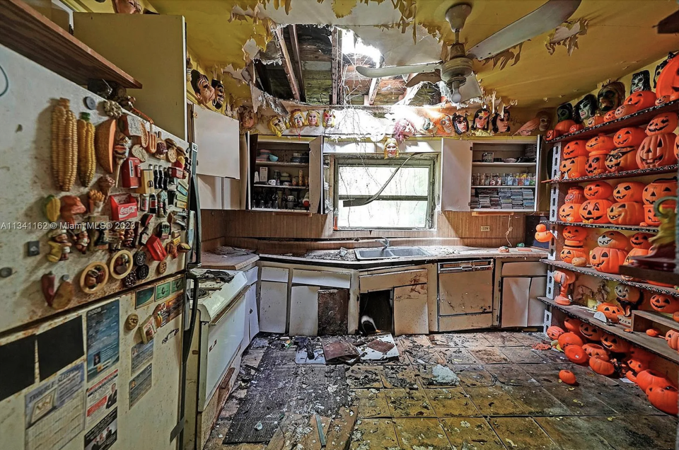 The home&#39;s dilapidated kitchen features a wall of jack-o&#39;-lanterns. / Credit: Zillow