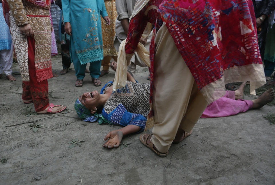 A Kashmiri woman cries during the funeral of her son, slain policeman Adil Ahmad, at Zaura village, about 62 kilometers south of Srinagar, Indian controlled Kashmir, Wednesday, Aug. 29, 2018. Rebels fighting against Indian rule ambushed a group of police officers and killed four of them, including Ahmad, on Wednesday in the disputed Himalayan region of Kashmir, police said. (AP Photo/Mukhtar Khan)