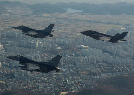 A U.S. Air Force F-35A Lightning II assigned to Hill Air Force Base, Utah, conducts a training flight with F-16 Fighting Falcons assigned to Kunsan Air Base, South Korea over the city of Gunsan, in South Korea. Courtesy Josh Rosales/U.S. Air Force/Handout via REUTERS