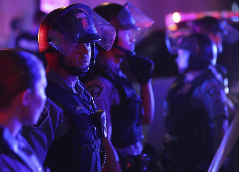 Minneapolis police secure an intersection along 7th St. during unrest near Nicollet Mall Wednesday, Aug. 26, 2020 in Minneapolis. The Minneapolis mayor imposed a curfew Wednesday night and requested National Guard help after unrest broke out downtown following what authorities said was misinformation about the death of a Black homicide suspect. (Jeff Wheeler/Star Tribune via AP)