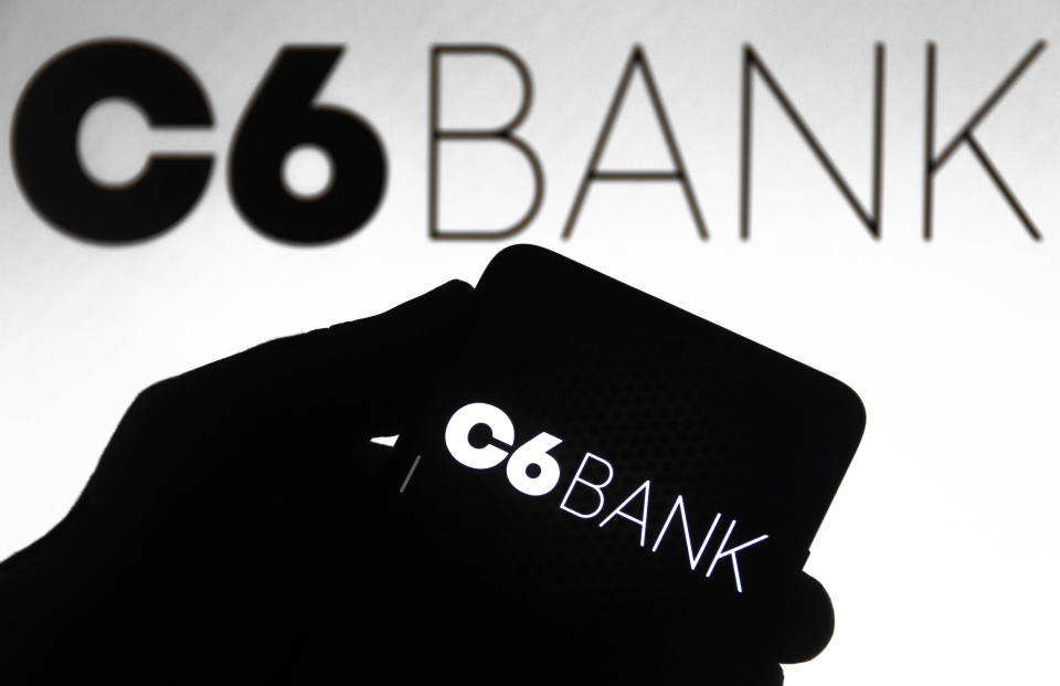 BRAZIL - 2021/10/30: In this photo illustration the C6 Bank logo seen displayed on a smartphone and on the background. (Photo Illustration by Rafael Henrique/SOPA Images/LightRocket via Getty Images)