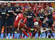 Liverpool's Steven Gerrard (C) takes a free kick during their English Premier League soccer match at Anfield, Liverpool, northern England September 1, 2013. REUTERS/Phil Noble