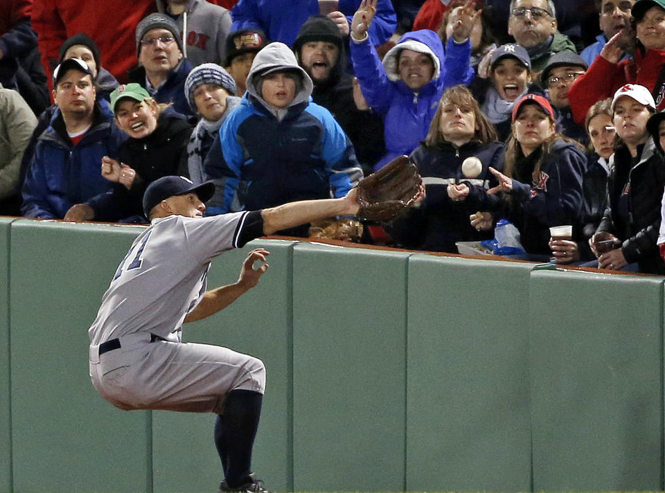 New York Yankees right fielder Brett Gardner cannot make the catch on a ground-rule double by Boston Red Sox's Mike Napoli during the third inning of a baseball game at Fenway Park in Boston, Wednesday, April 23, 2014. Dustin Pedroia scored on the hit. (AP Photo/Elise Amendola)