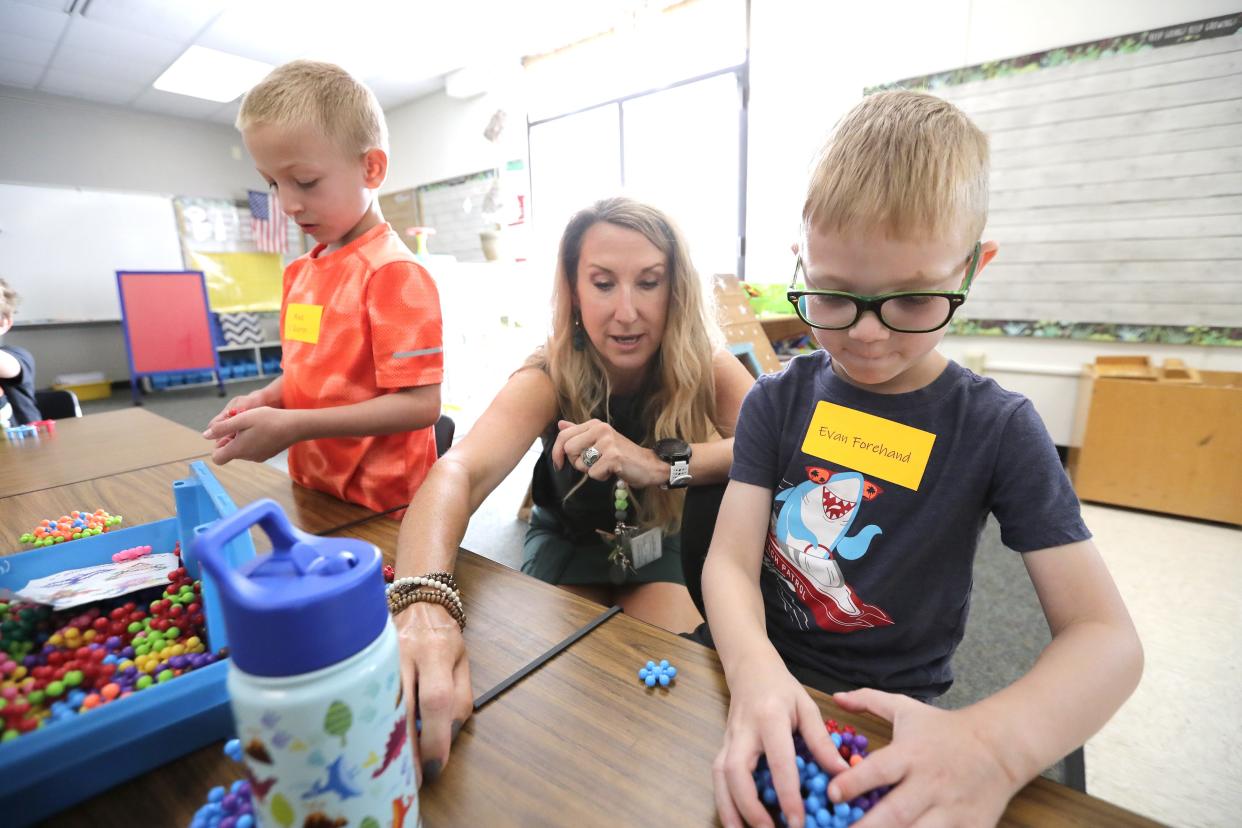 Sarah Slattery talks with Evan Forehand, right, during a session that uses table toys to help students with socialization during Kindergarten Camp Thursday at Westwood Elementary School in De Pere.