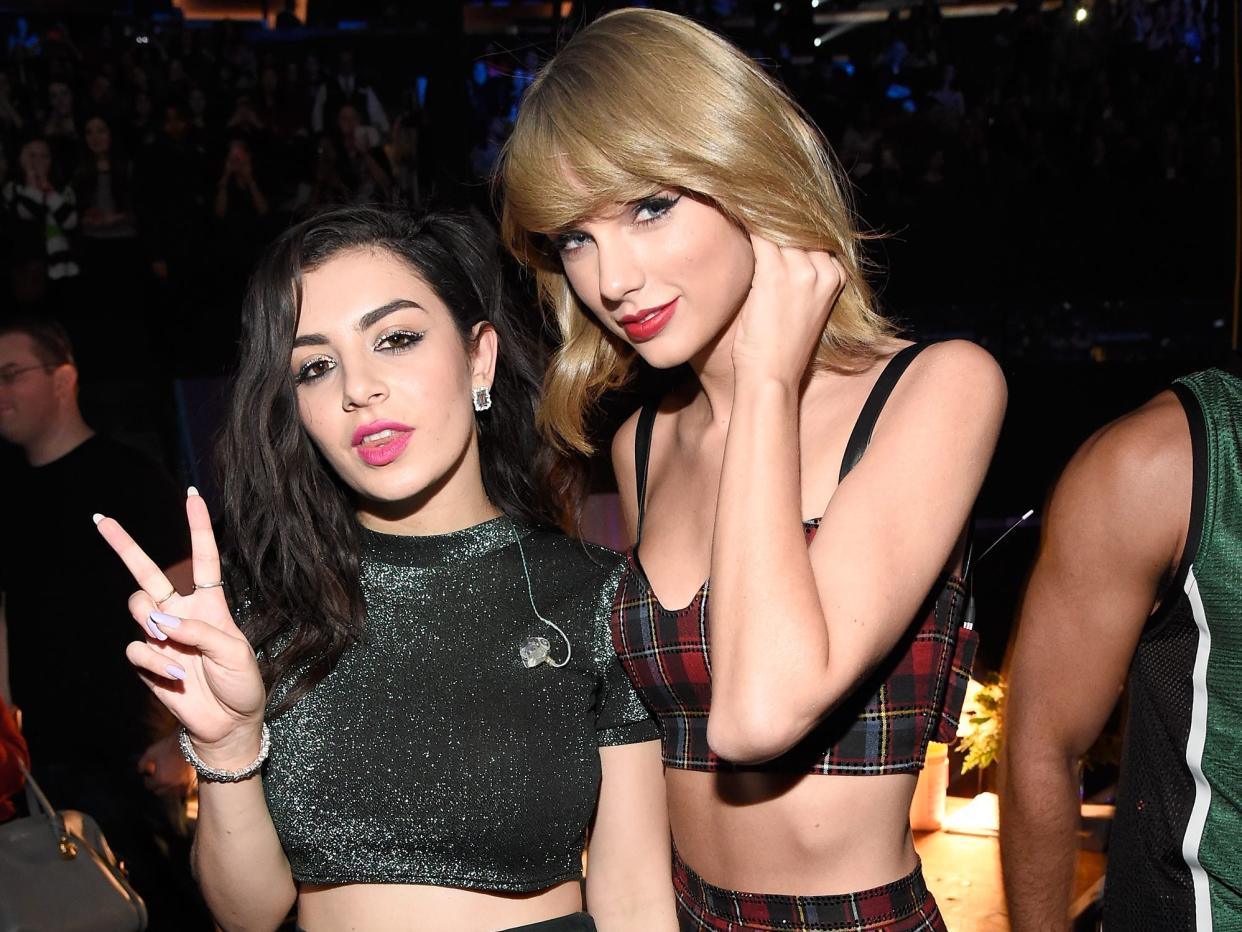 Charli XCX and Taylor Swift pose for a photo in 2014.