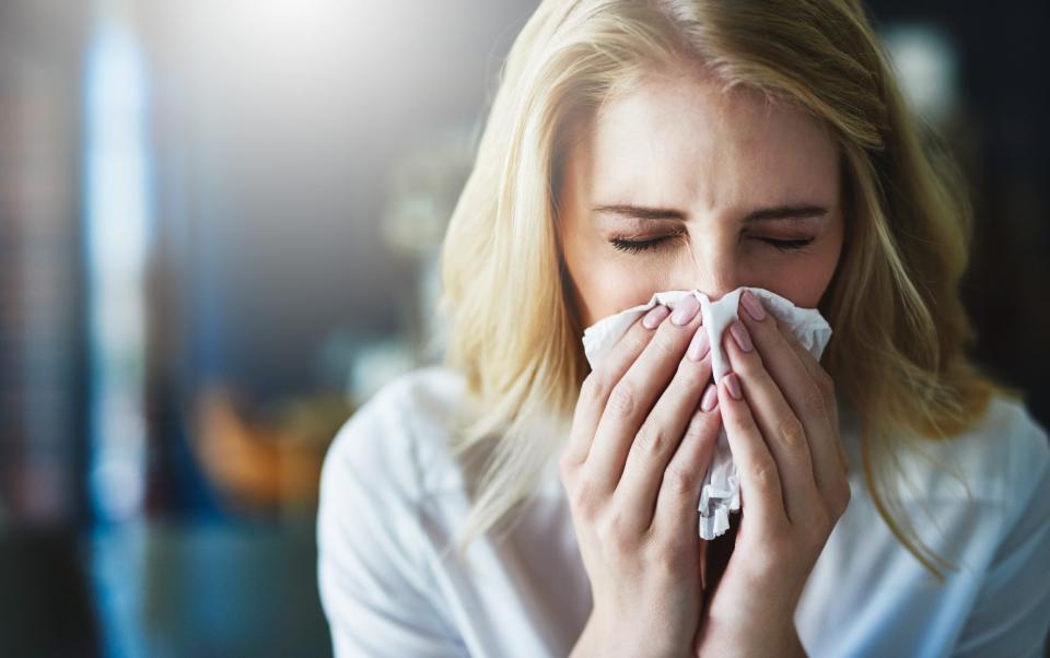 A woman sneezing