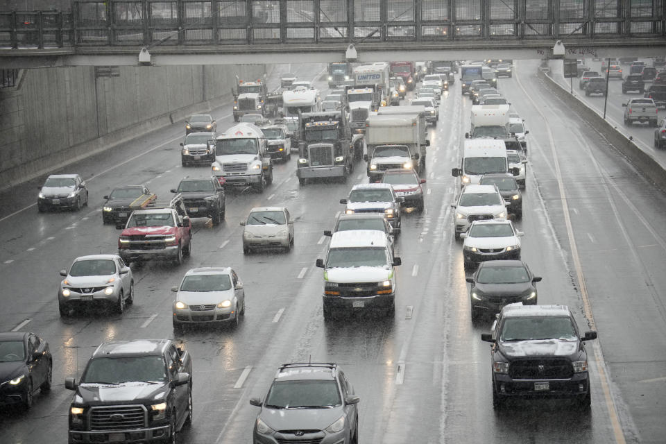 Motorists creep along southbound Interstate 25 at 15th Street as a light snow from a spring storm swept over the intermountain West Tuesday, April 4, 2023, in Denver. Forecasters predict that the storm will move out of the region on Tuesday and over the northern plains states where some locations could see up to two feet of snow. (AP Photo/David Zalubowski)