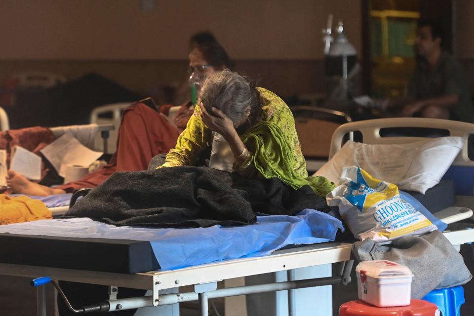 A patient rests inside a banquet hall temporarily converted into a Covid-19 coronavirus ward in New Delhi on April 27, 2021. (Photo by Money SHARMA / AFP) (Photo by MONEY SHARMA/AFP via Getty Images)