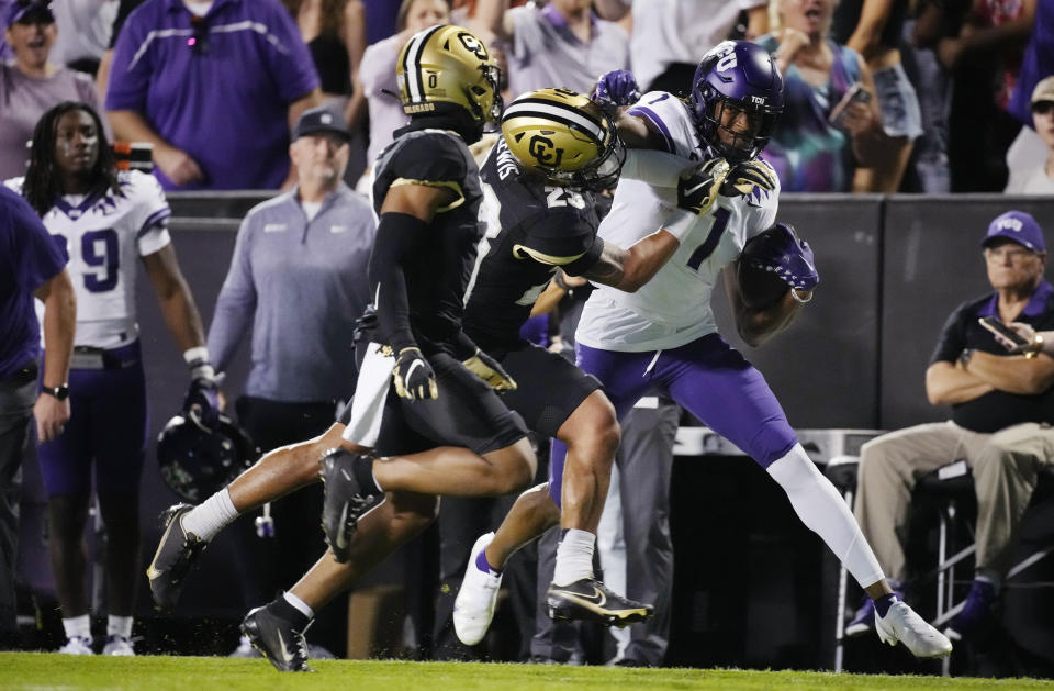 TCU wide receiver Quentin Johnston, right, is stopped by Colorado safety Isaiah Lewis as cornerback Kaylin Moore watches during the first half of an NCAA college football game Friday, Sept. 2, 2022, in Boulder, Colo. (AP Photo/David Zalubowski)