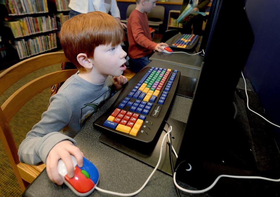 Owen Kaydus, 5, of Springfield works on the computer in the children's section of the Lincoln Library in Springfield Wednesday Jan. 25, 2023.