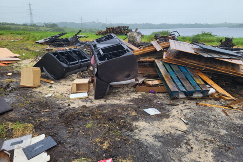 An image of sofas and other household furniture as well as wooden pallets dumped at the Stoneyford  Reservoir site.