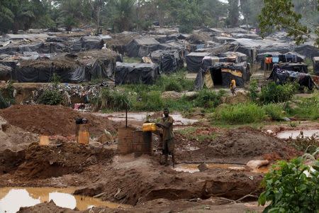 A camp for gold prospectors is seen around a gold mine near the village of Gamina in western Ivory Coast, March 16, 2015. REUTERS/Luc Gnago