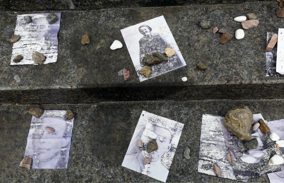 Small stones placed on the photos of victims of the 1941 massacre where the Nazi killed tens of thousands of Jews during WWII, in Kyiv, Ukraine. <a href="https://newsroom.ap.org/detail/UkraineBabiYar/0aec67cc9c0643218df03fc6ad8cadd5/photo?Query=ukraine%20jews%20massacre&mediaType=photo&sortBy=&dateRange=Anytime&totalCount=95&currentItemNo=42" rel="nofollow noopener" target="_blank" data-ylk="slk:AP Photo/Efrem Lukatsky;elm:context_link;itc:0;sec:content-canvas" class="link ">AP Photo/Efrem Lukatsky</a>