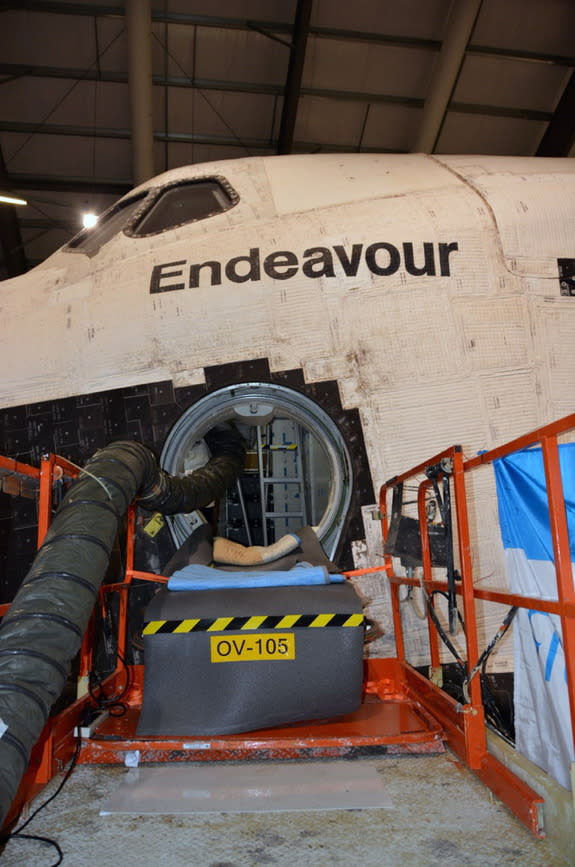 Behind-the-scenes photographs reveal how the water storage tanks deep inside NASA's space shuttles Atlantis and Endeavour were extracted by the space agency for their use onboard the International Space Station.