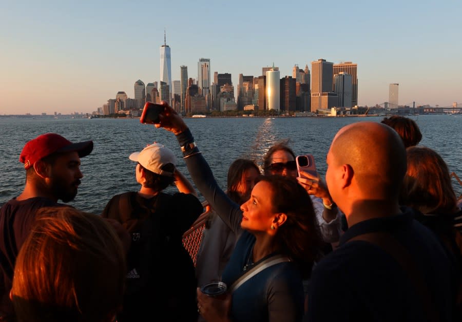 People ride the Staten Island Ferry as the sun sets on August 19, 2023, in New York City. (Photo by Gary Hershorn/Getty Images)