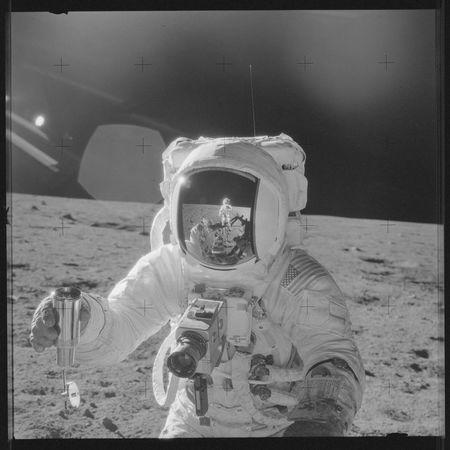 Astronaut Alan L. Bean holds a Special Environmental Sample Container filled with lunar soil collected during the Apollo 12 mission November 19, 1969. Mission commander Charles Conrad Jr., who took this picture, is reflected in Bean's helmet visor. REUTERS/NASA/Handout