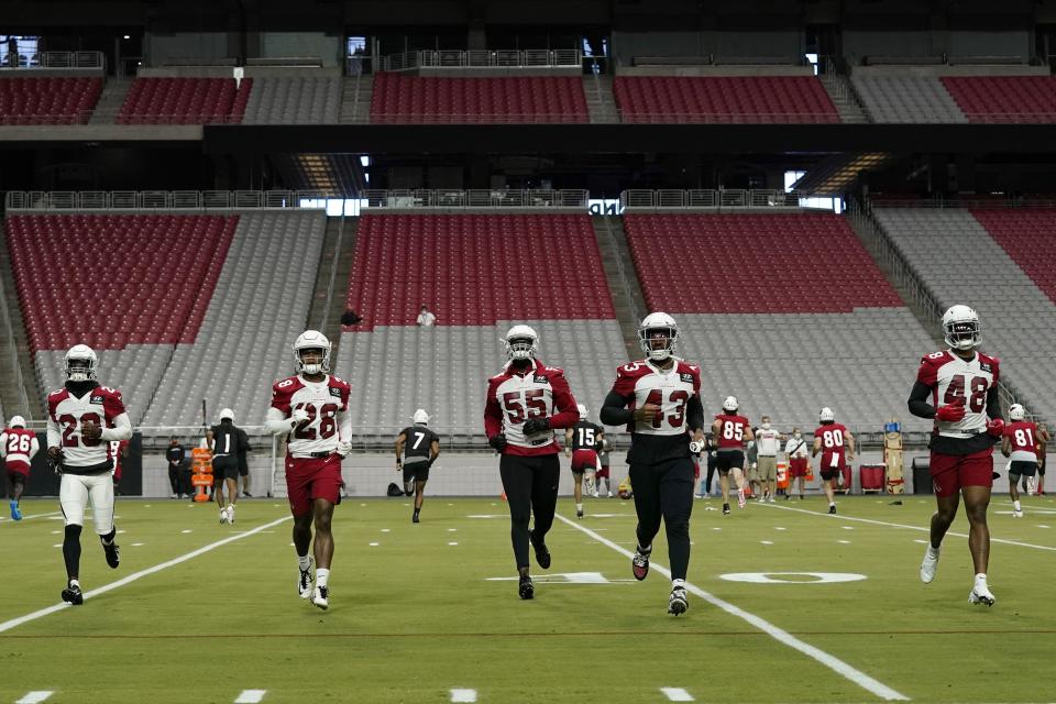 From left to right, Arizona Cardinals' Duke Thomas, Charles Washington, Chandler Jones, Haason Reddick and Isaiah Simmons run sprints during an NFL football workout inside State Farm Stadium Wednesday, Aug. 12, 2020, in Glendale, Ariz. (AP Photo/Ross D. Franklin)