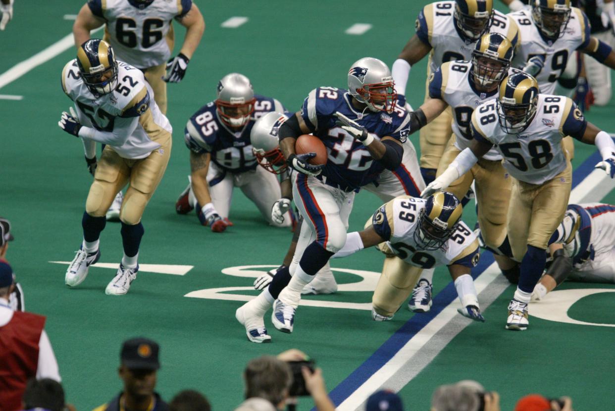 Antowain Smith #32 of the New England Patriots is chased by the St.Louis Rams during Superbowl XXXVI at the Superdome in New Orleans, Louisiana.