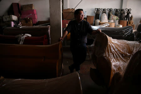 "Drag Race Thailand" contestant Assadayut Khunviseadpong 'Natalia Pliacam' poses next to Chinese style coffins at his house in Bangkok, Thailand March 18, 2018. REUTERS/Athit Perawongmetha