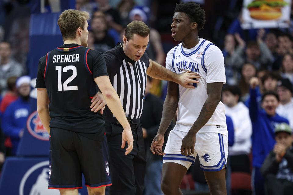 Dec 20, 2023; Newark, New Jersey, USA; Seton Hall Pirates guard Dre Davis (14) and Connecticut Huskies guard Cam Spencer (12) are separated by an official during the second half at Prudential Center. Mandatory Credit: Vincent Carchietta-USA TODAY Sports