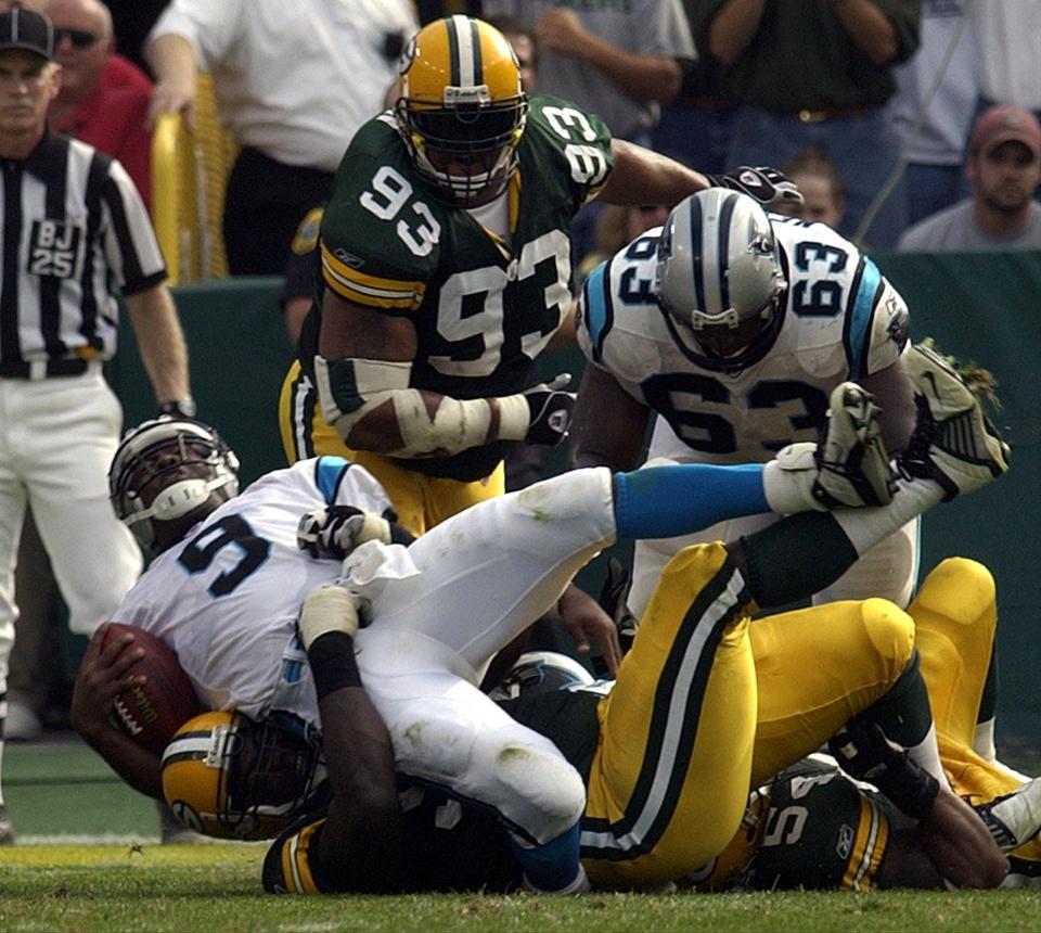 Carolina Panthers quarterback Rodney Peete is sacked by Green Bay Packers Cletidus Hunt.