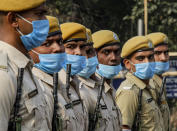 Indian policemen wearing face mask to prevent the spread of the coronavirus march during rehearsals of Republic Day parade in Kolkata, India, Friday, Jan. 22, 2021. (AP Photo/Bikas Das)