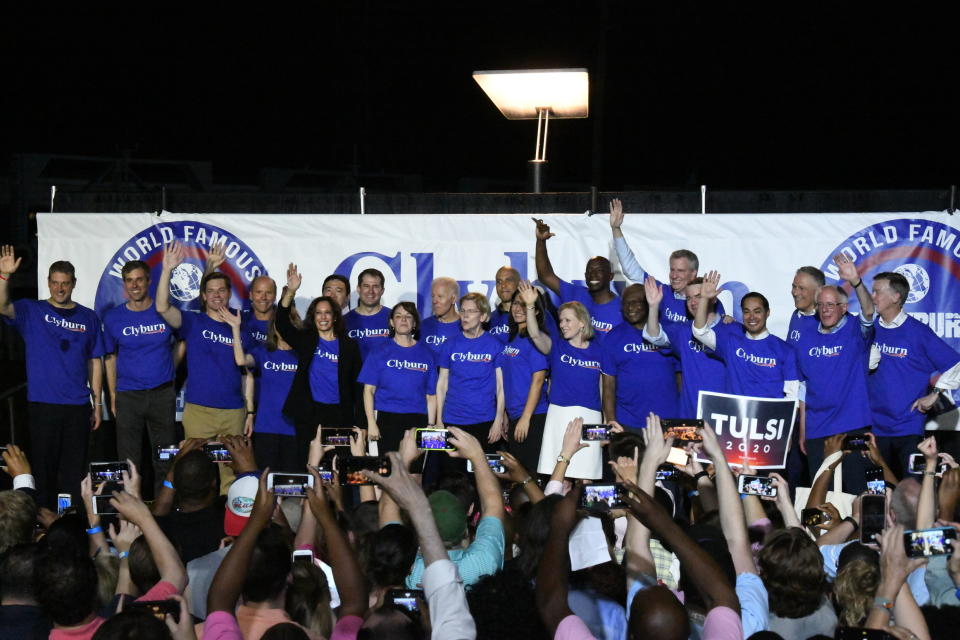 Twenty-one of the Democrats seeking the party's presidential nomination pose together after House Majority Whip Jim Clyburn's "World Famous Fish Fry," Friday, June 21, 2019, in Columbia, S.C. (AP Photo/Meg Kinnard)