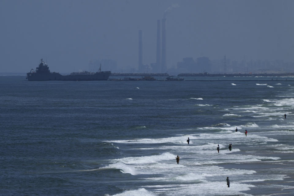 A ship is seen off the coast of Gaza near a U.S.-built floating pier that will be used to facilitate aid deliveries, as seen from the central Gaza Strip, Thursday, May 16, 2024. (AP Photo/Abdel Kareem Hana)