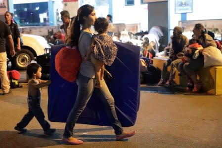 Venezuelan migrants walk at the Binational Border Service Center of Peru in Tumbes