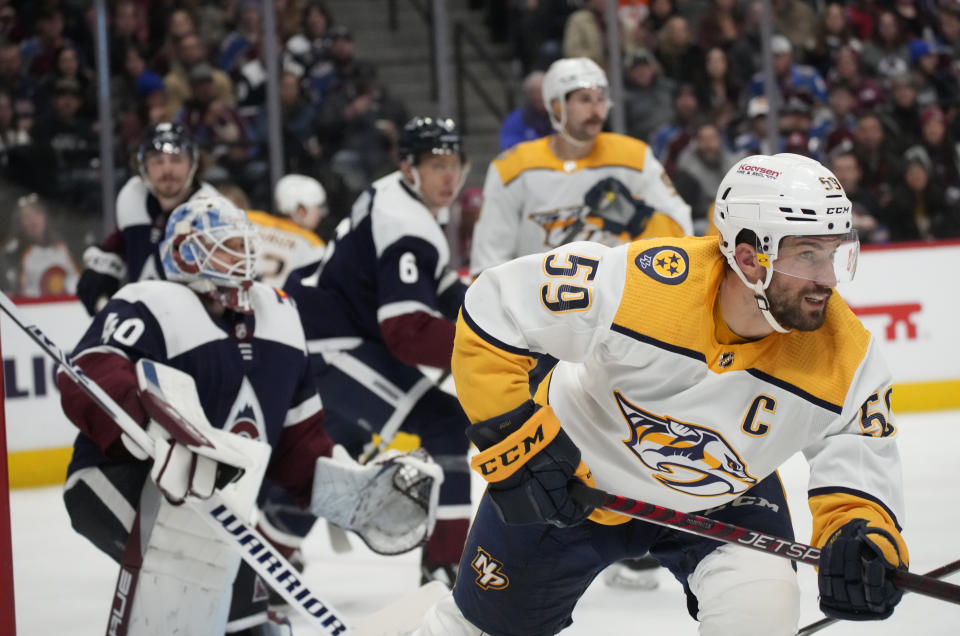 Nashville Predators defenseman Roman Josi, front, pursues the puck in the second period of an NHL hockey game against the Colorado Avalanche Saturday, Dec. 17, 2022, in Denver. (AP Photo/David Zalubowski)