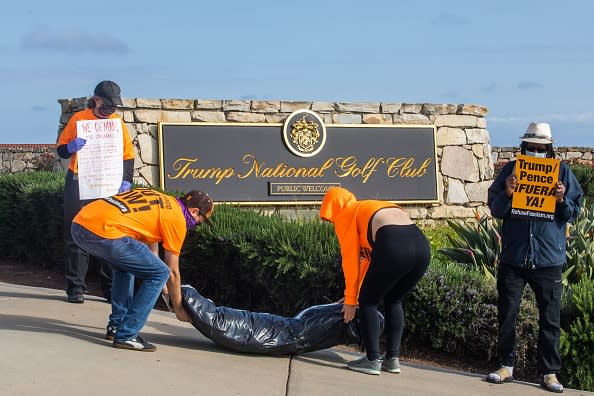 RefuseFascism supporters deliver symbolic home-made body-bags in front of the Trump National Golf Club during an anti-Trump protest.