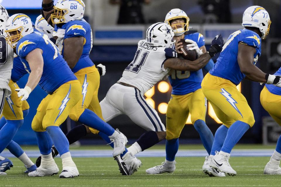 Cowboys linebacker Micah Parsons (11) sacks quarterback Justin Herbert (10) during Chargers' last drive.