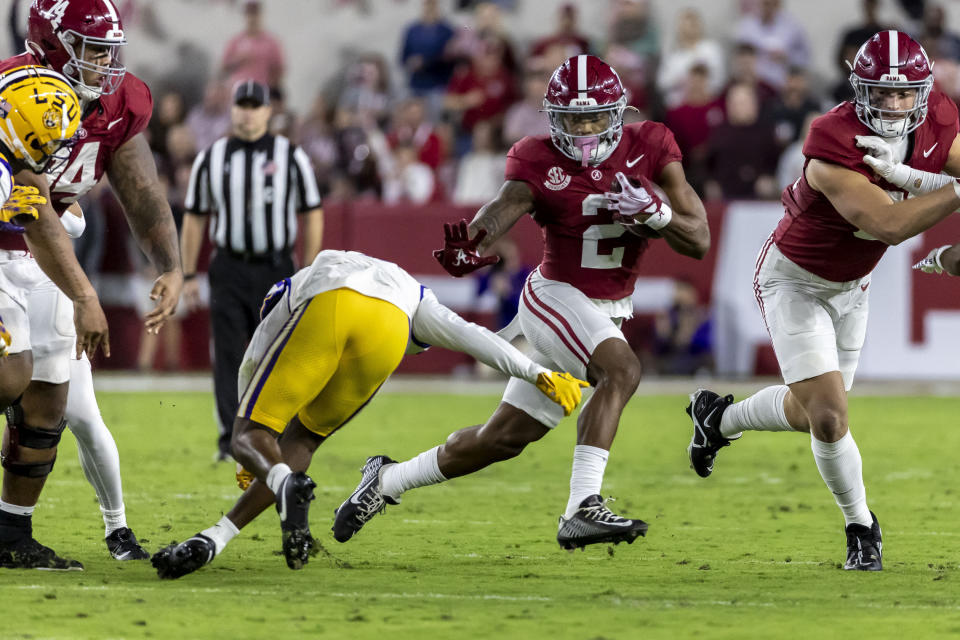 Alabama running back Jase McClellan (2) runs the ball against LSU safety Andre' Sam, left, during the first half of an NCAA college football game, Saturday, Nov. 4, 2023, in Tuscaloosa, Ala. (AP Photo/Vasha Hunt)